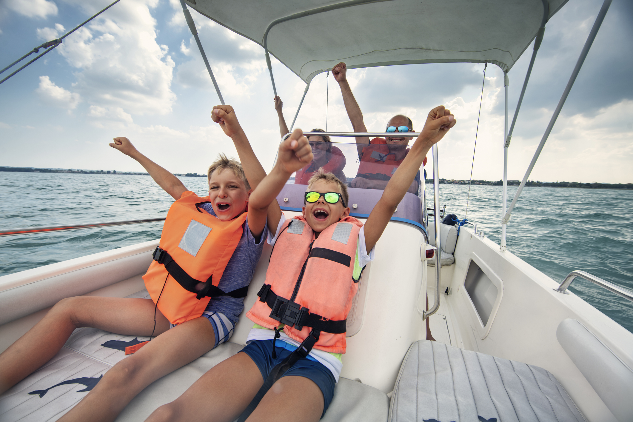 Family enjoying Garda Lake holidays. Parents and kids riding a boat on Lake Garda.Nikon D850